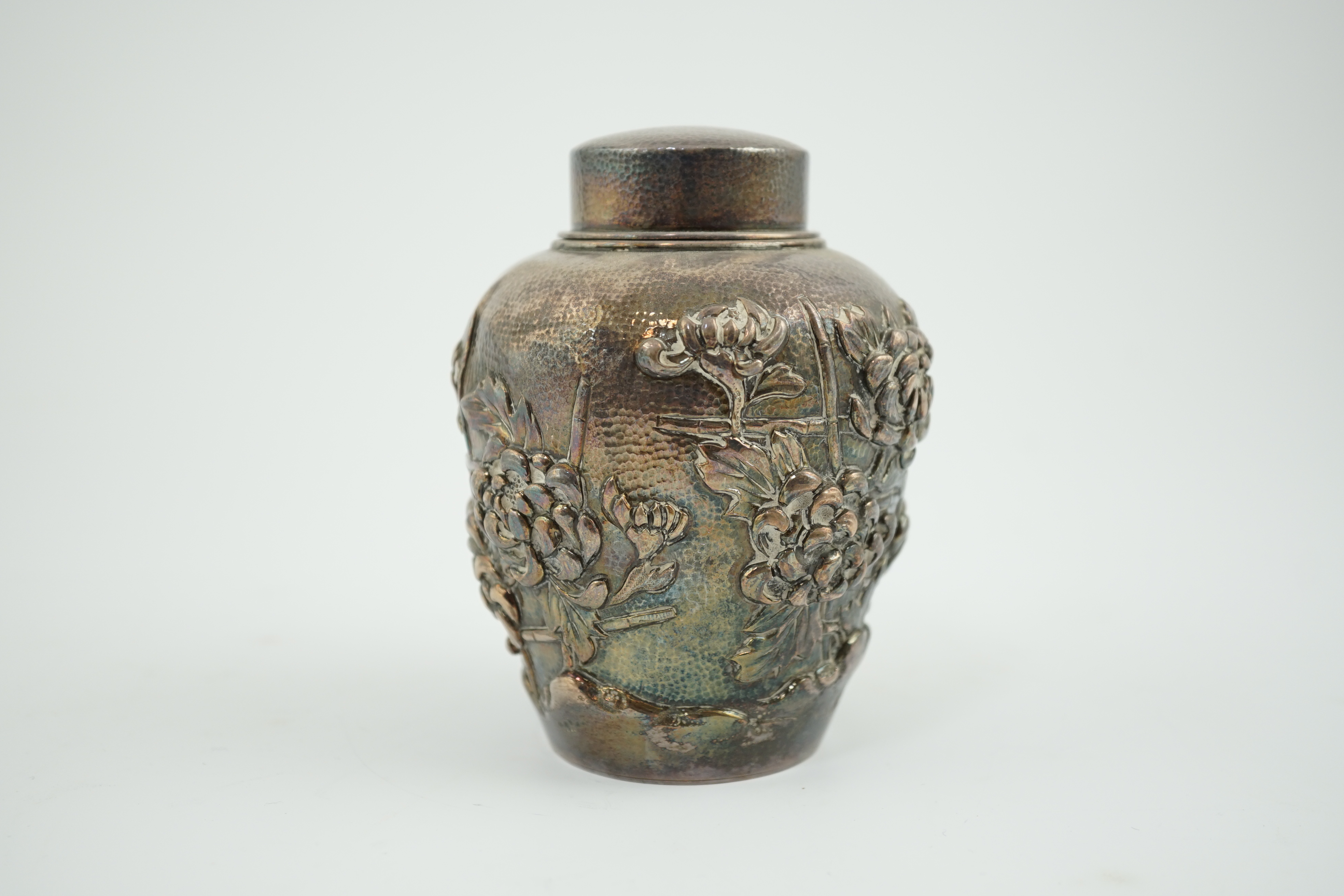 An early 20th century Japanese silver ovoid tea caddy and cover, decorated with prunus, together with a similar Japanese silver bowl